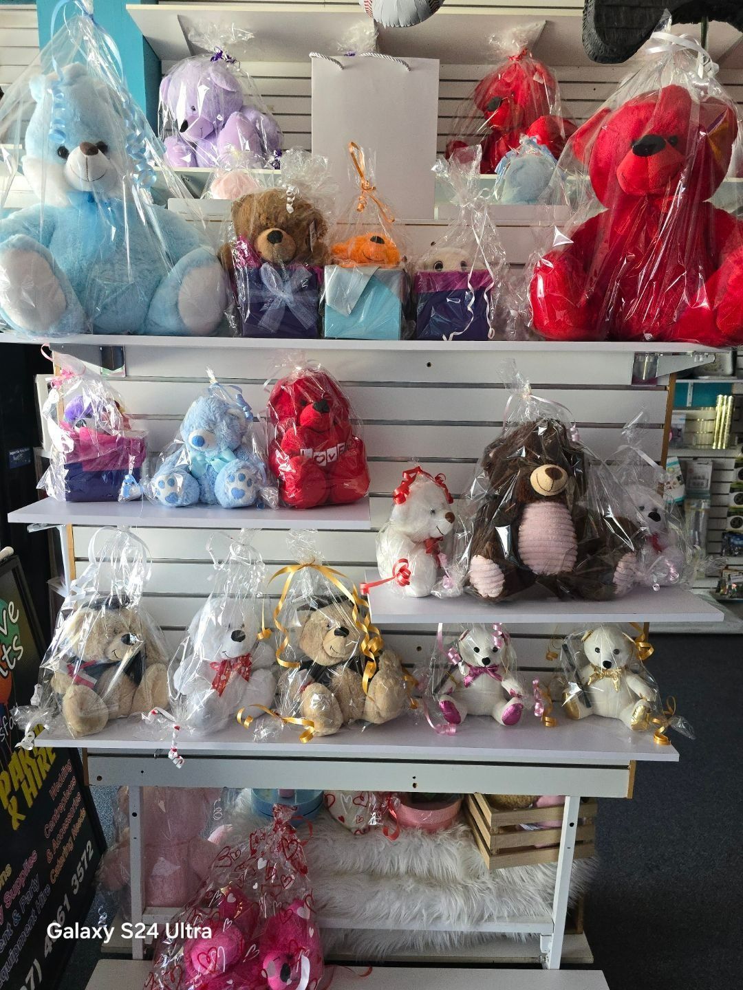 Shelves Displaying Various Teddy Bears and Gift Boxes Wrapped in Cellophane — Creative Events Innisfail in Innisfail, QLD