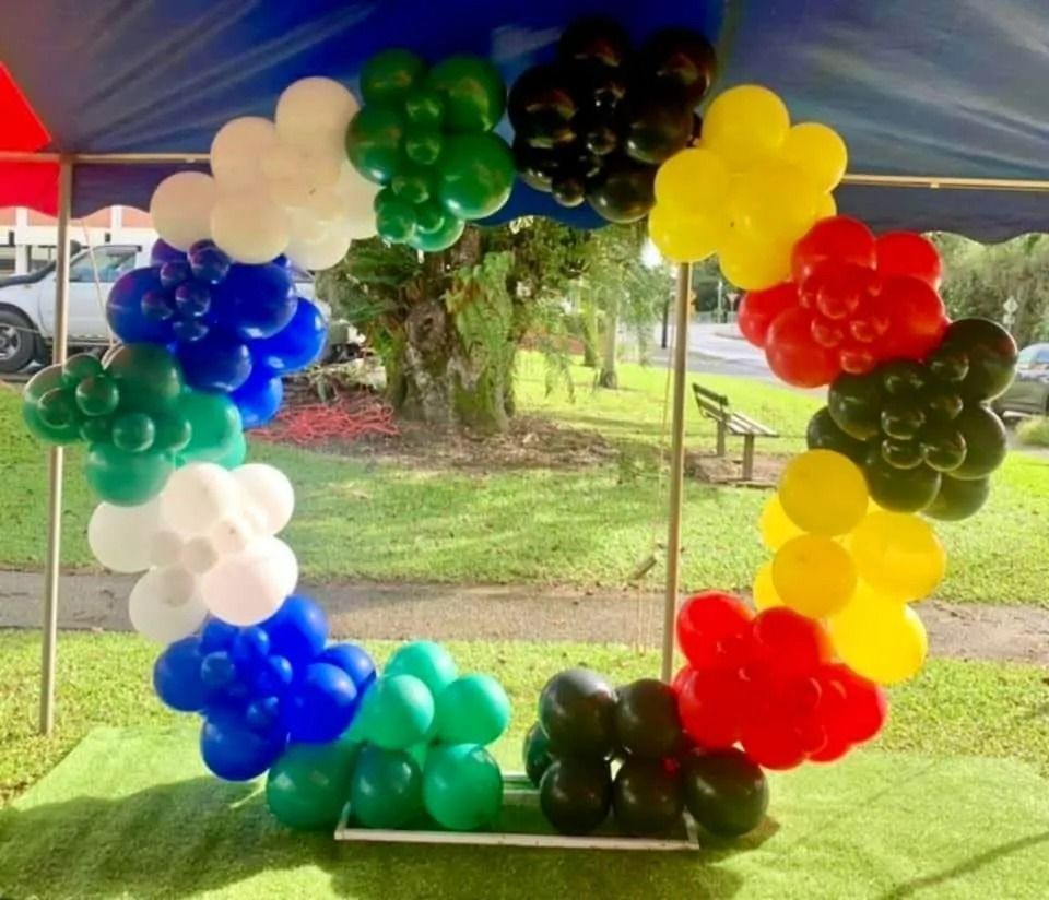 Colorful Balloon Arch in Olympic Rings Colors, Set Outdoors on Grass — Creative Events Innisfail in Mission Beach, QLD