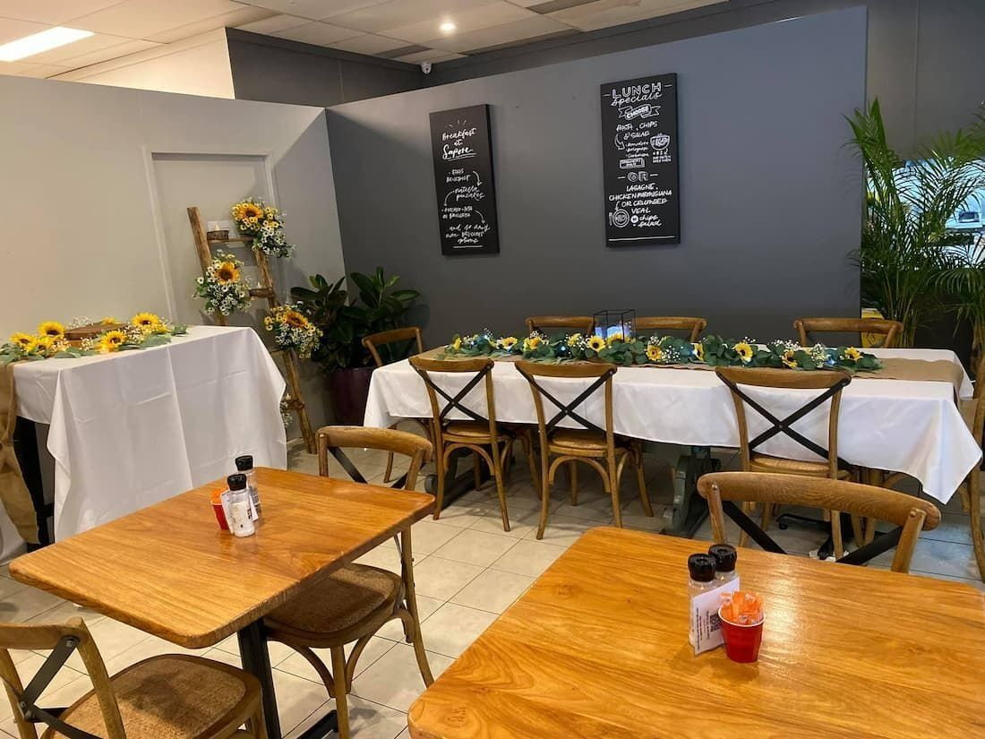 Restaurant Interior With Wooden Tables and Cross-back Chairs — Creative Events Innisfail in Innisfail, QLD