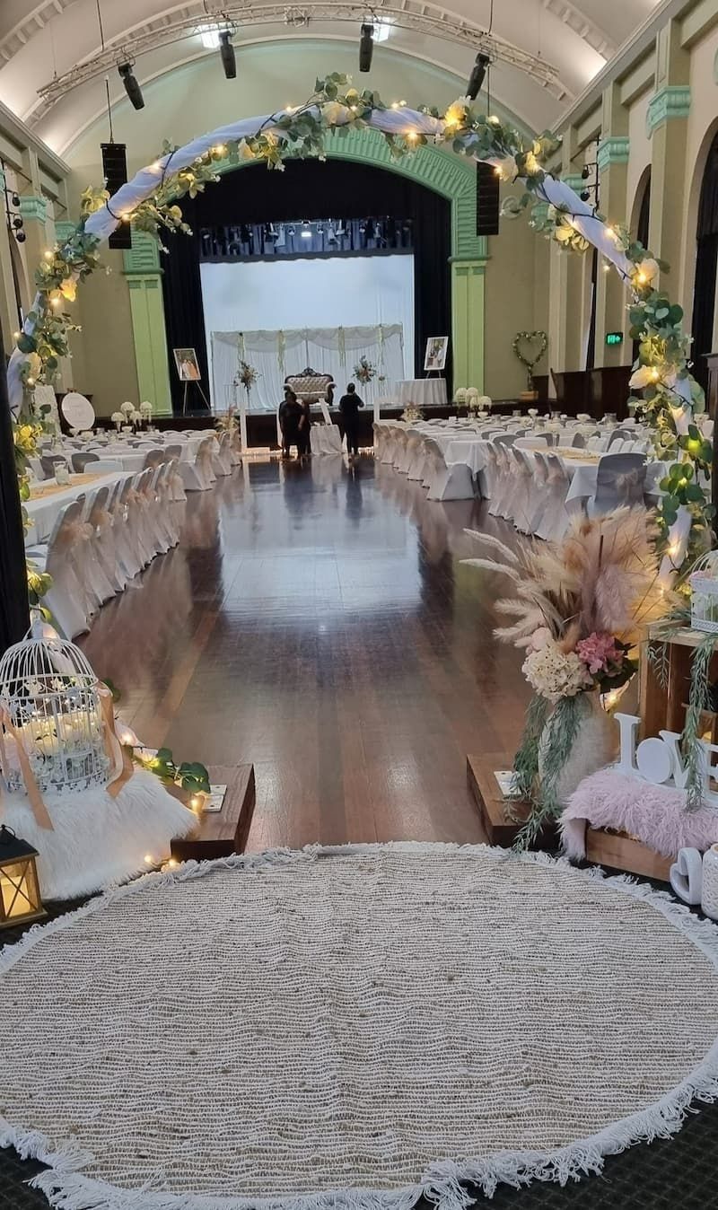 Wedding Reception Hall, Aisle With Rug, Decorated Arch, Tables With Chairs — Creative Events Innisfail in Babinda, QLD