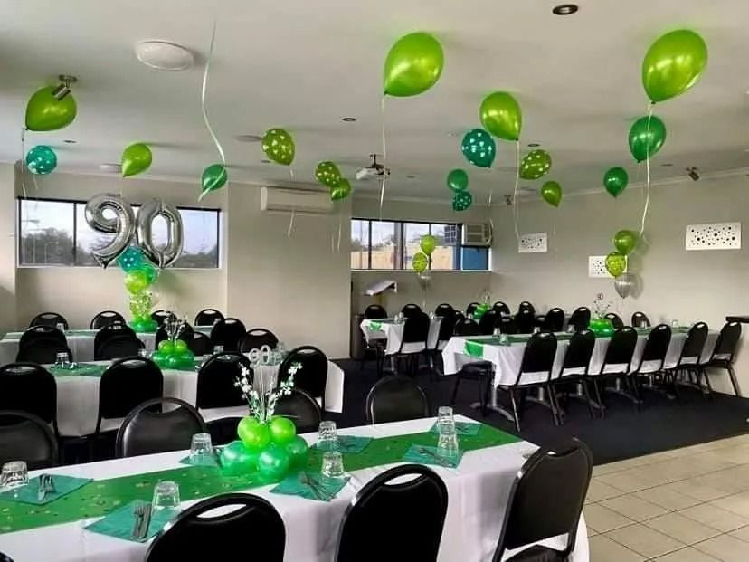 Party Room Decorated With Green Balloons and Table Settings — Creative Events Innisfail in Tully, QLD
