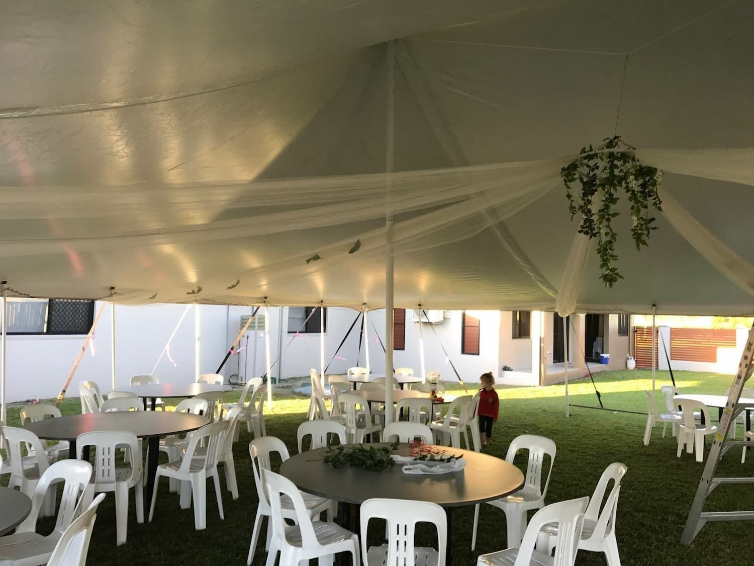 White Tent With Tables and Chairs Set Up on Grass — Creative Events Innisfail in Mission Beach, QLD