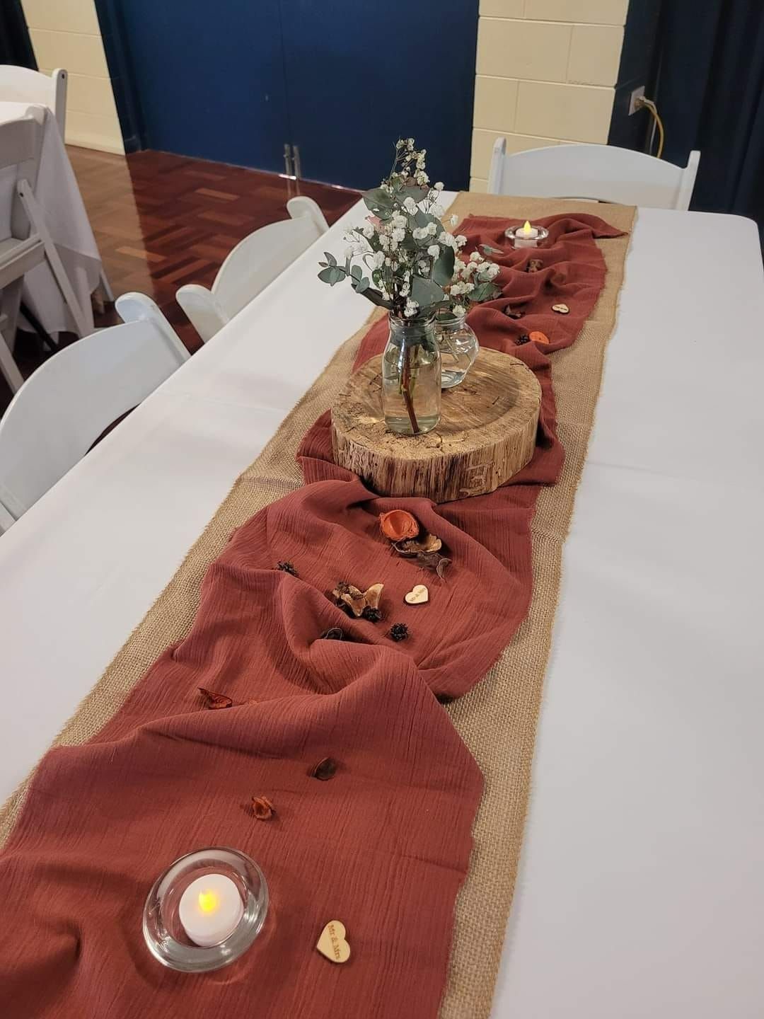 Table Setting With Floral Centerpiece and Terracotta-colored Runner — Creative Events Innisfail in Tully, QLD