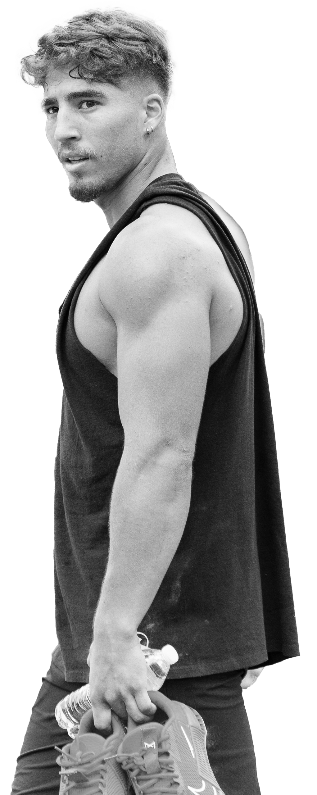 A very muscular man is standing with his hands on his hips.