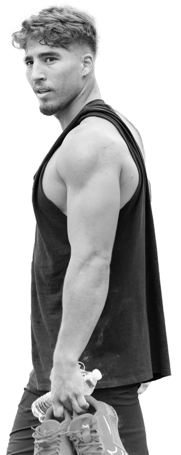 A very muscular man is standing with his hands on his hips.