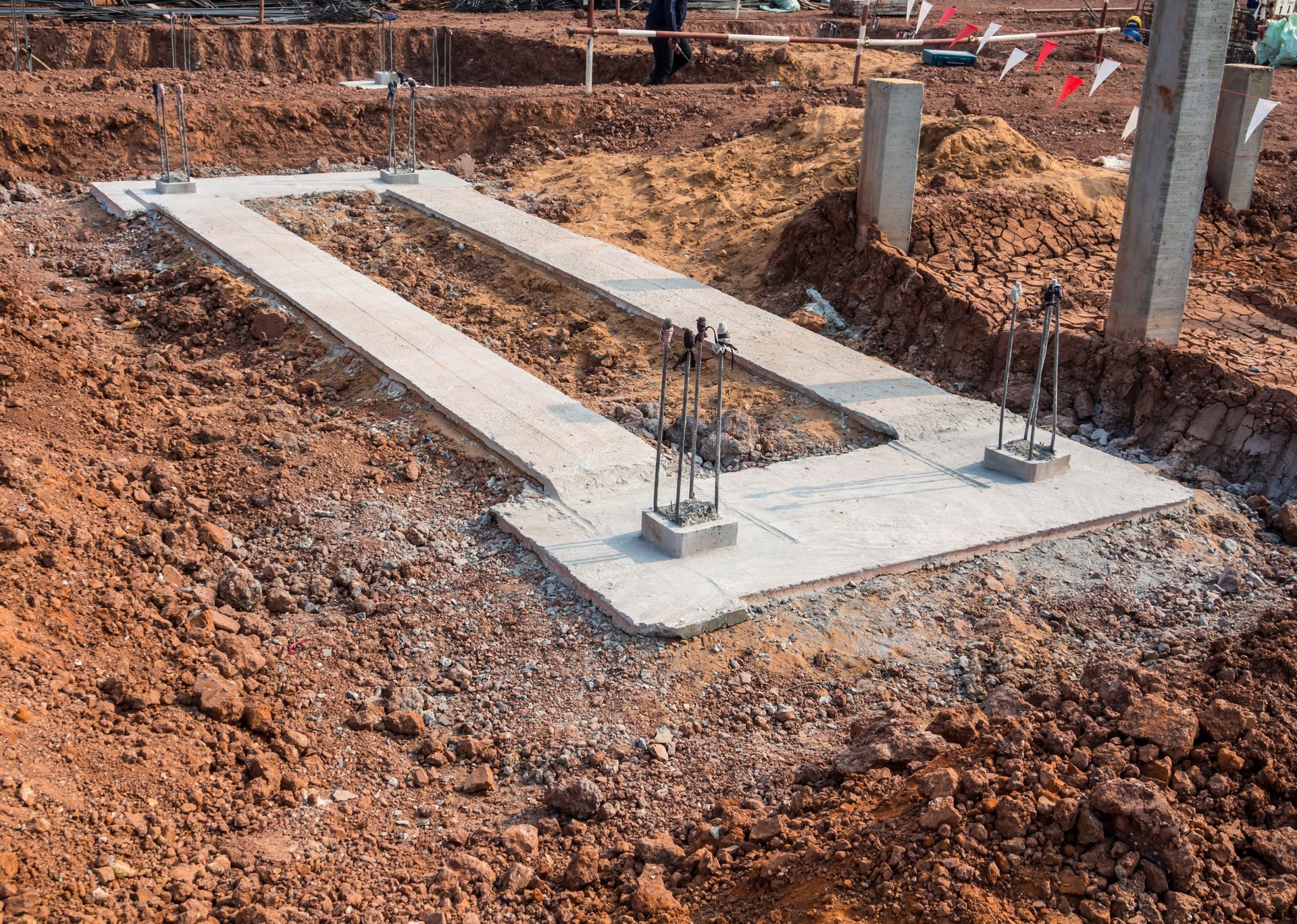 A concrete slab is sitting in the middle of a dirt field.