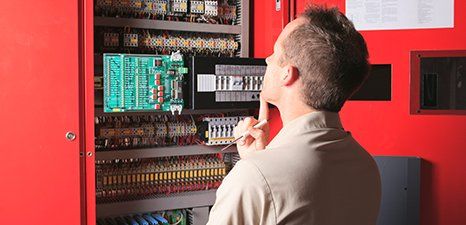 Commercial Electrical Services — Electrician Checking on Electrical Circuits in Grants Pass, OR