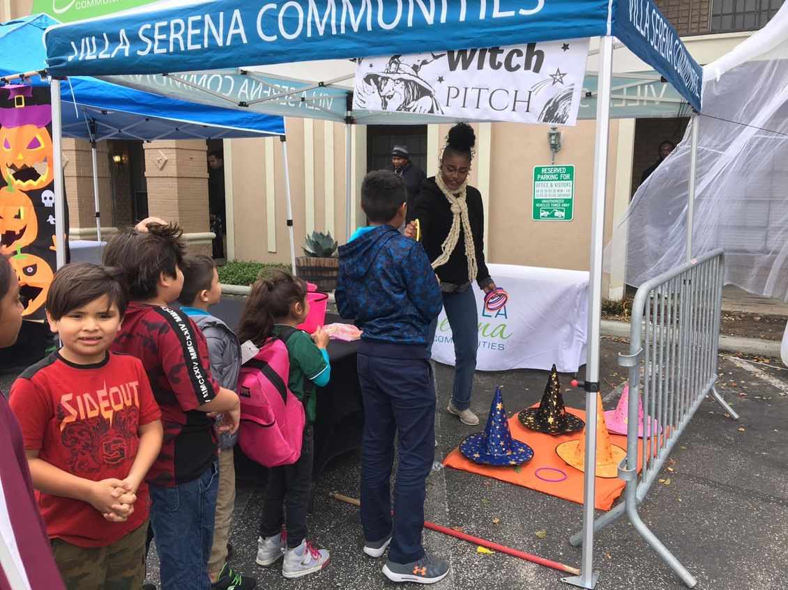 A group of children are standing under a tent.