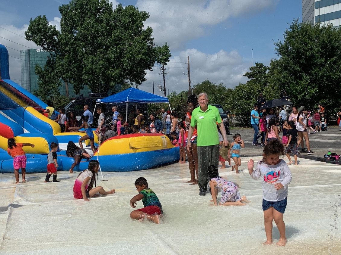 A group of children are playing in a water park.