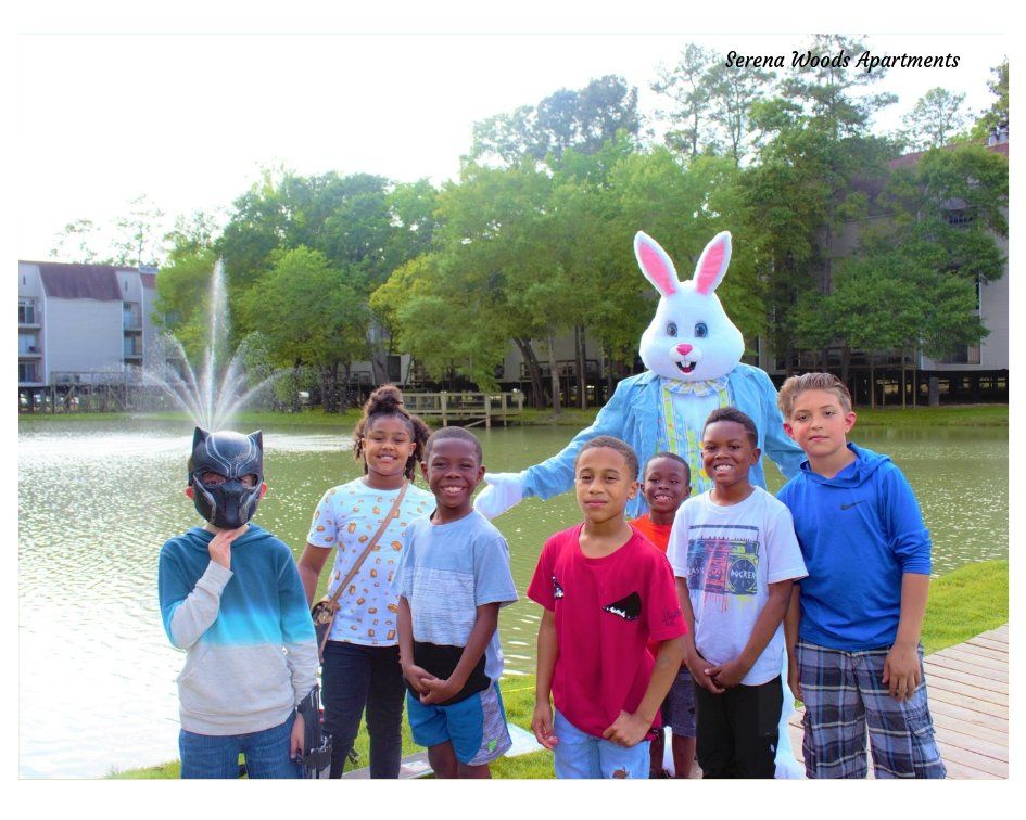 A group of children posing for a picture with a bunny costume