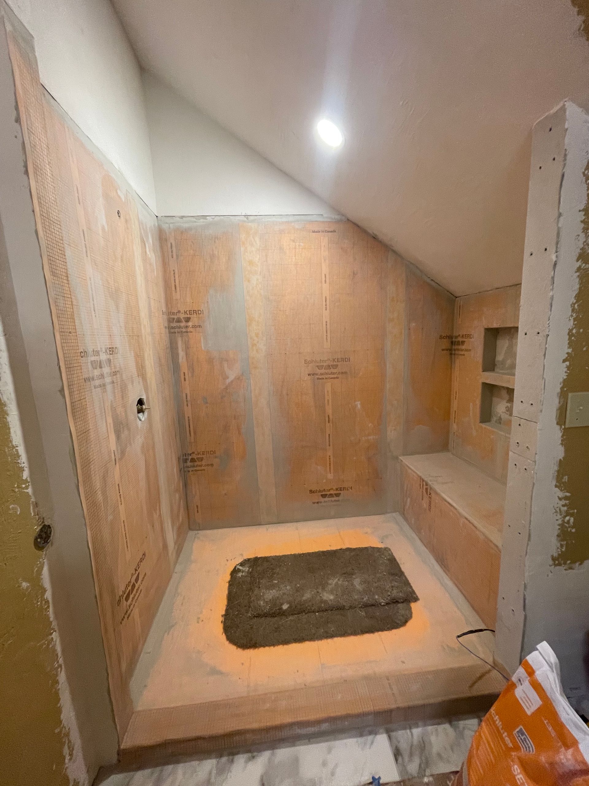 A bathroom is being remodeled with a concrete floor.