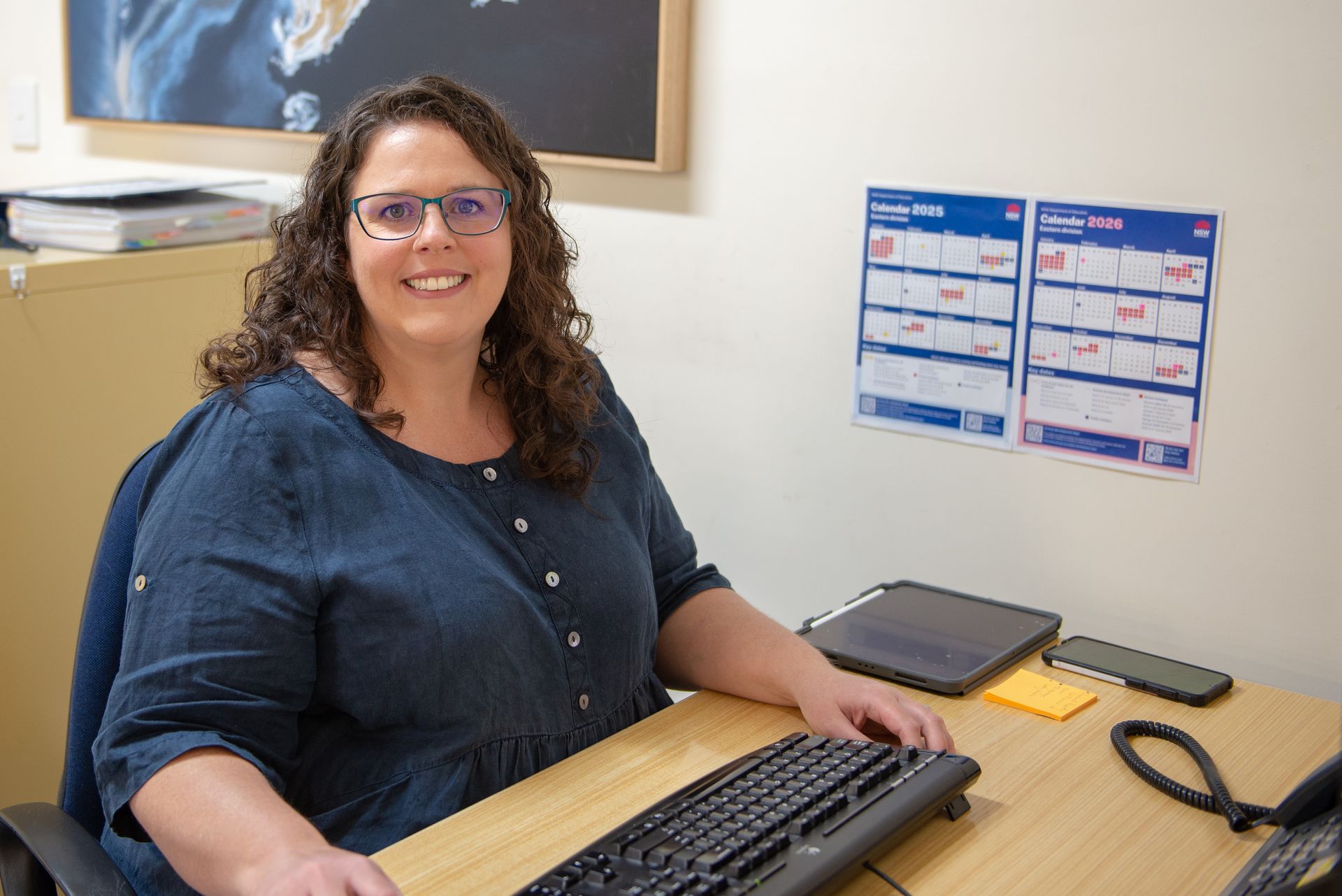 Woman in blue shirt seated at a desk — Wright Partners in Dubbo, NSW