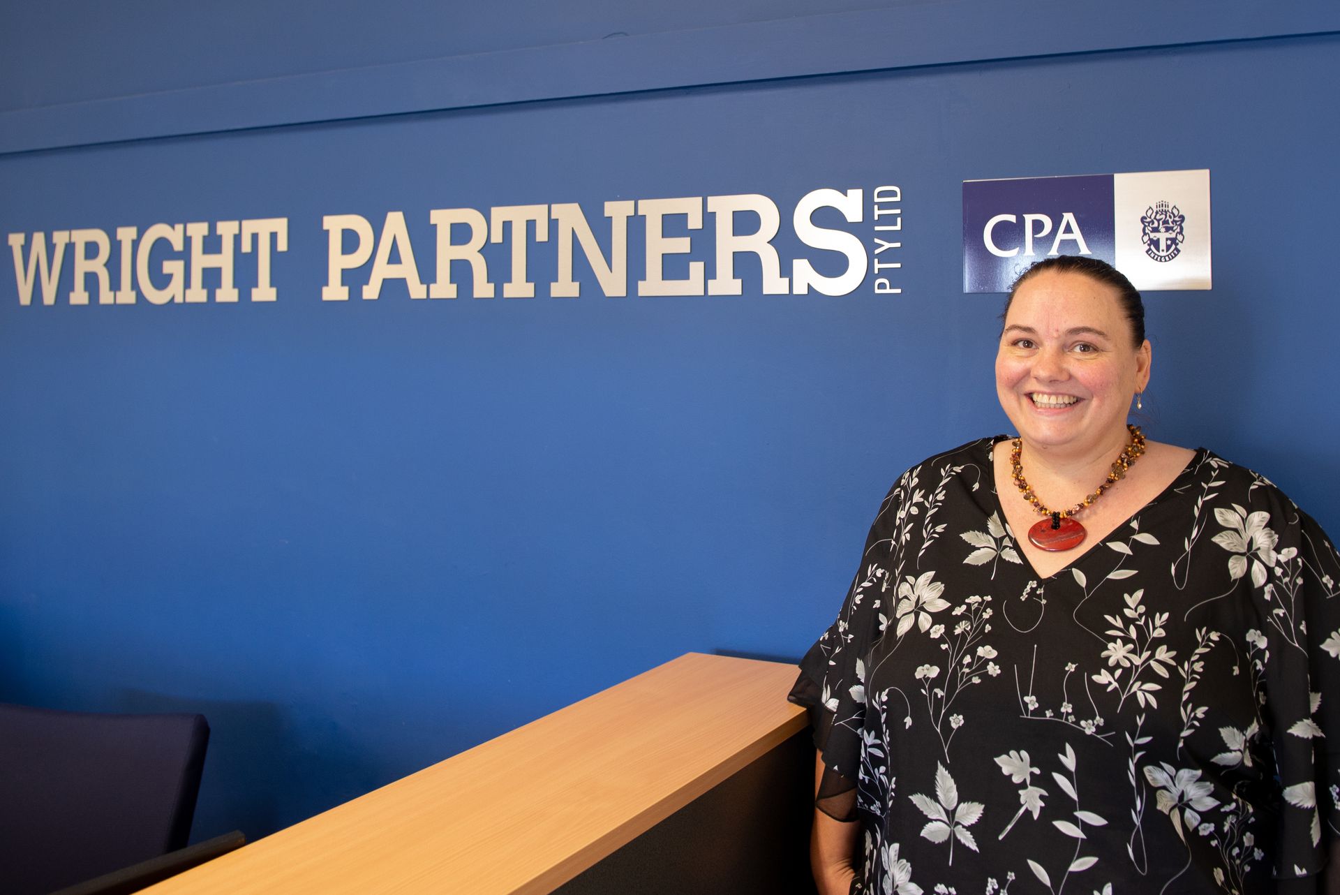 Woman smiles near the 