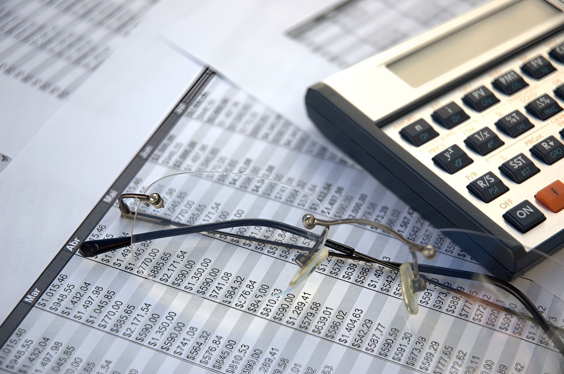 Calculator and Glasses on Top of A Spreadsheet with Financial Data — Wright Partners in Wellington, NSW