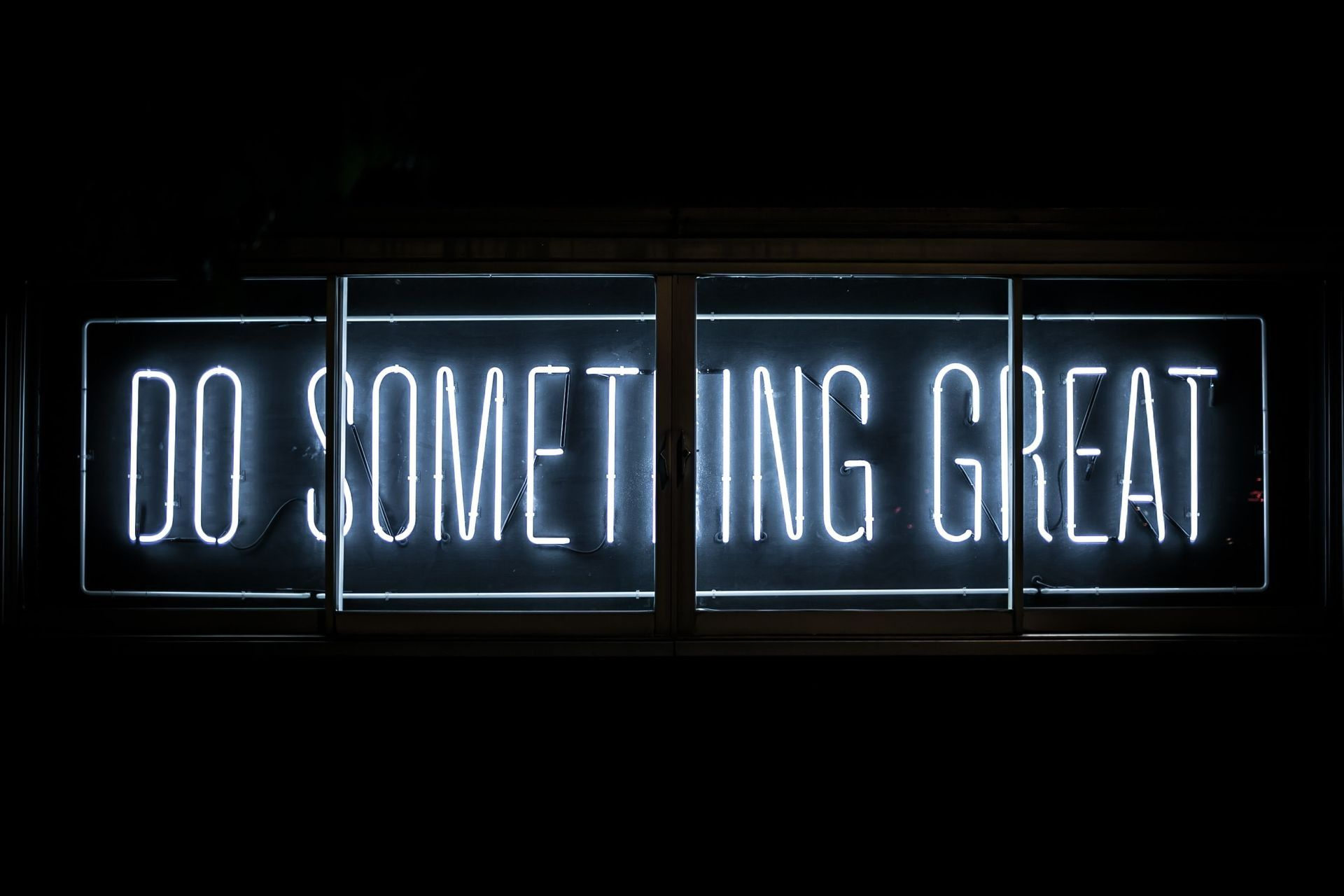 Neon Sign in A Dark Room Reads Do Something Great — Wright Partners in Dubbo, NSW