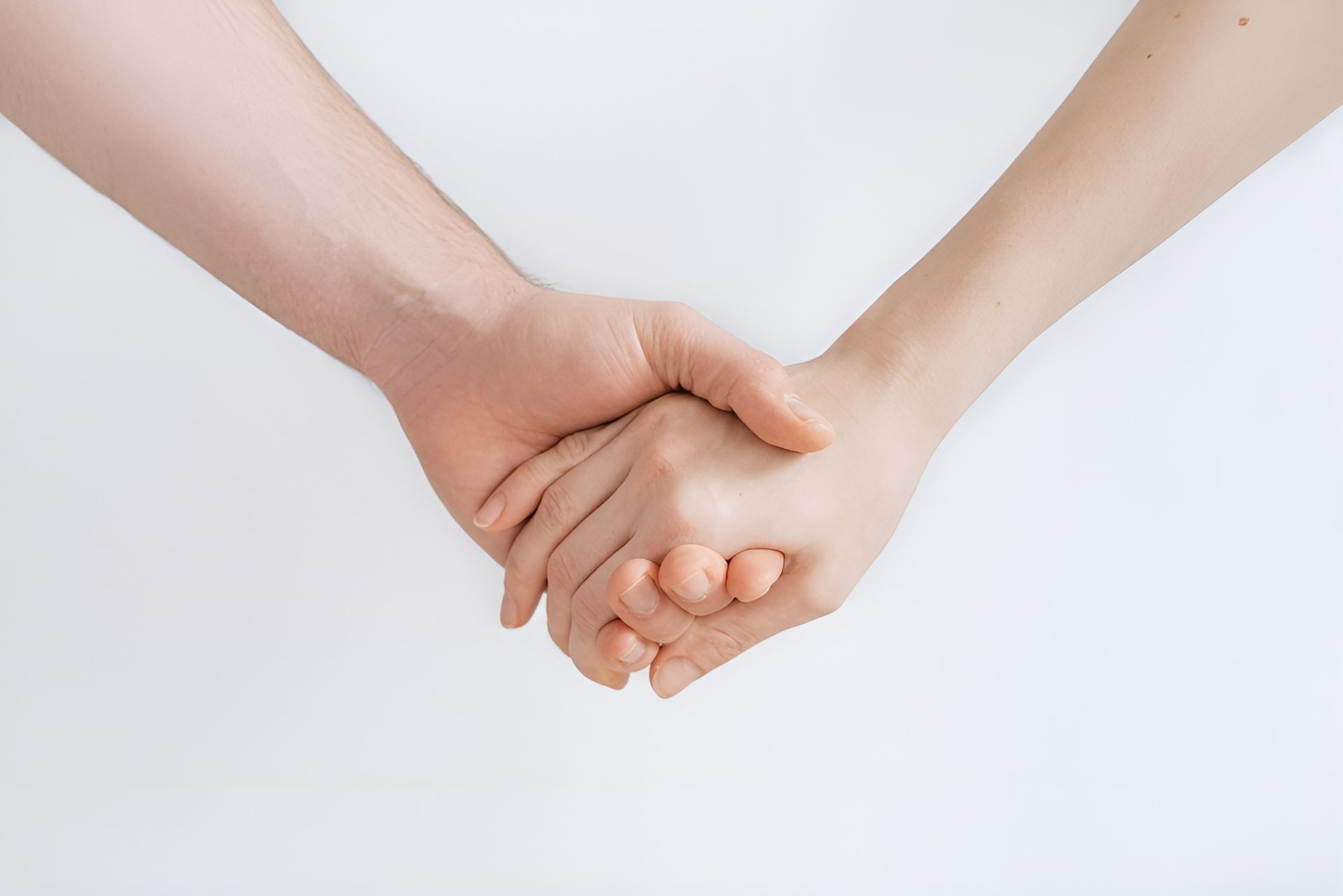 Two Hands Clasped Together, Held Against a White Background — Wright Partners in Dubbo, NSW