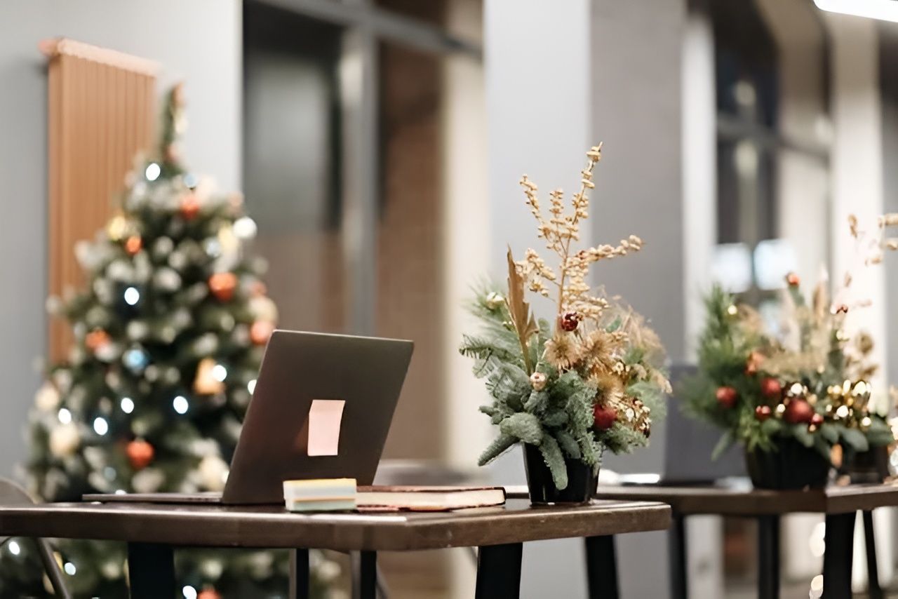 A Laptop and Floral Arrangements on Tables with A Christmas Tree — Wright Partners in Dubbo, NSW