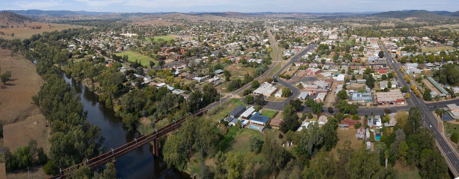 Aerial View of A Town with A River, Bridge, and Scattered Buildings — Wright Partners in Wellington, NSW