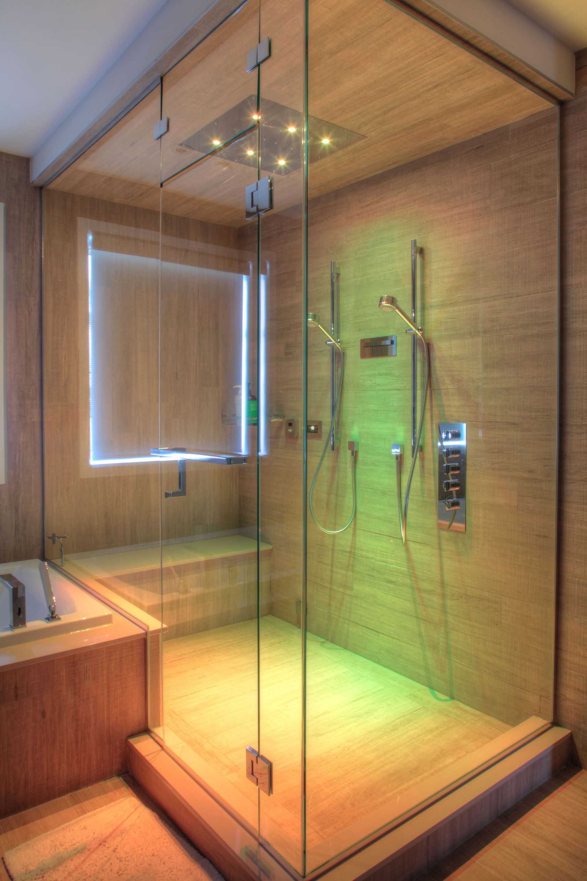 Modern glass shower doors in a stylish bathroom by County Glass & Mirror, St. Louis, MO, enhancing e