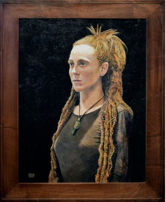 A framed painting of a woman with dreadlocks