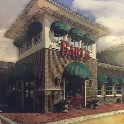 Pizza Parlor storefront, red neon sign, brick building, people eating inside, open sign.