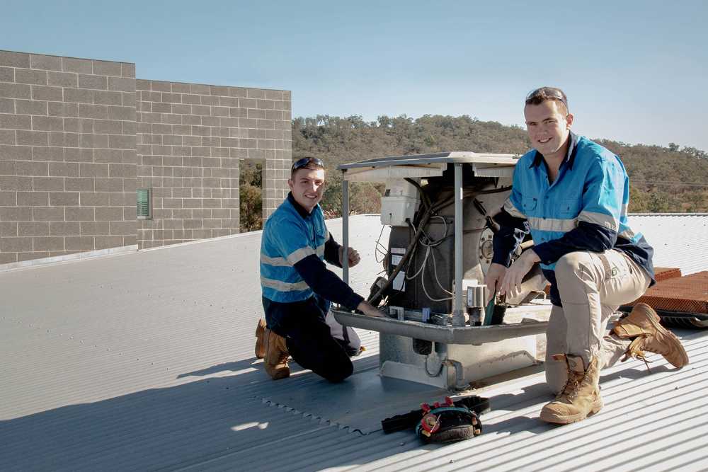 Two Electrician Fixing the Aircon —  Local Electrical Contractors in Tamworth