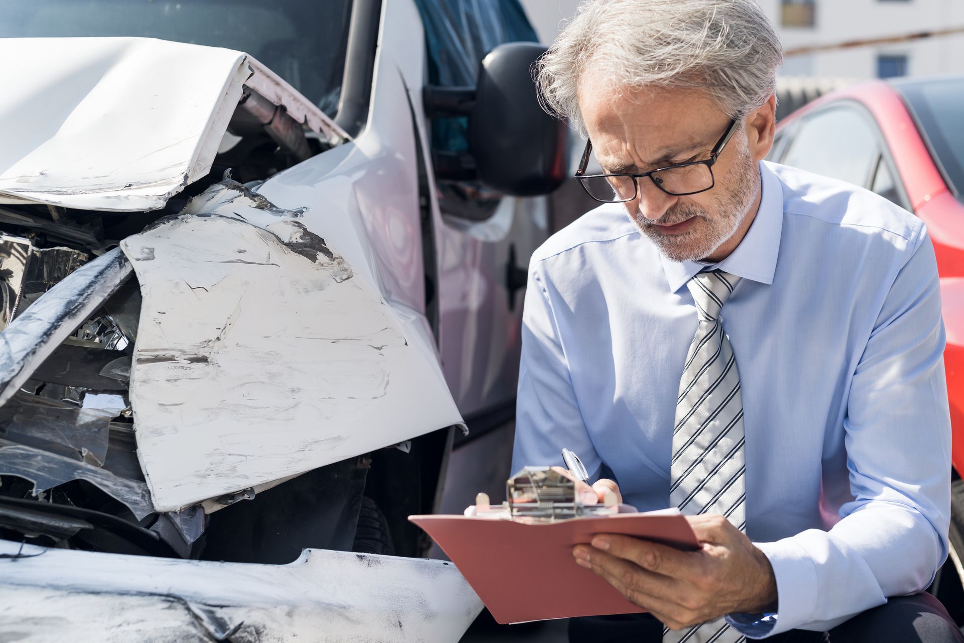 An insurance adjustor checking the damage of the accident 