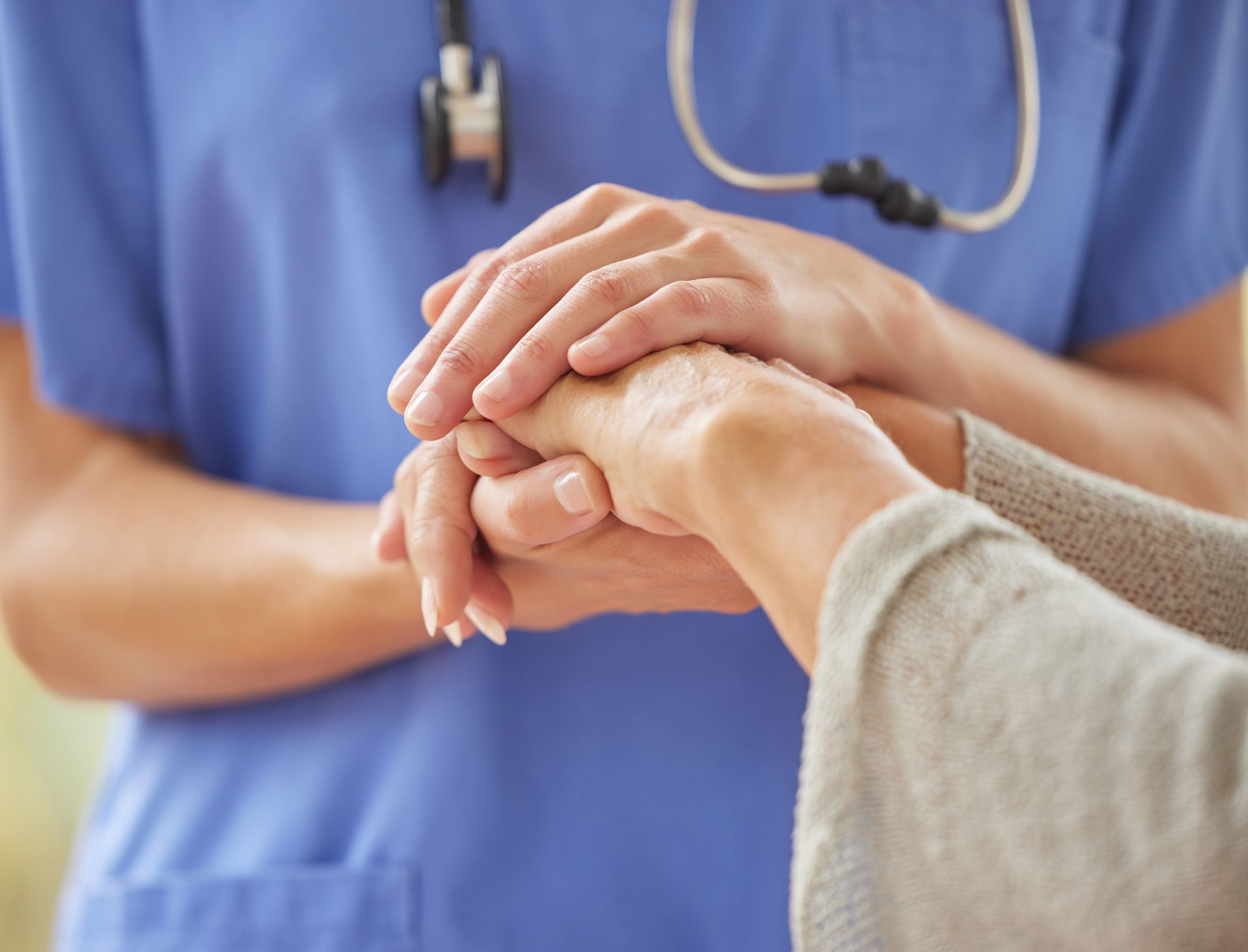 Nurse Holding the Hands of Patient