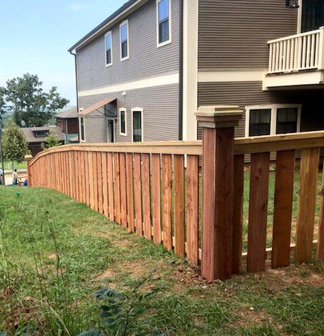 short wooden fence with spaced slats and taller posts