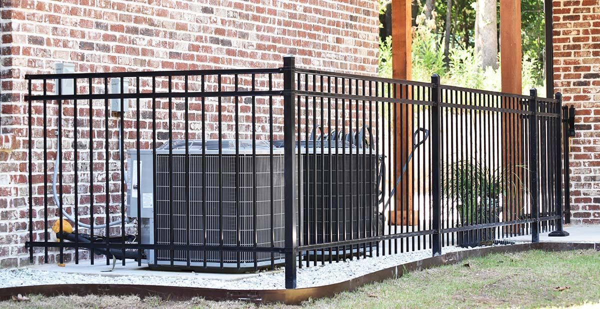 iron fence surrounding air conditioner