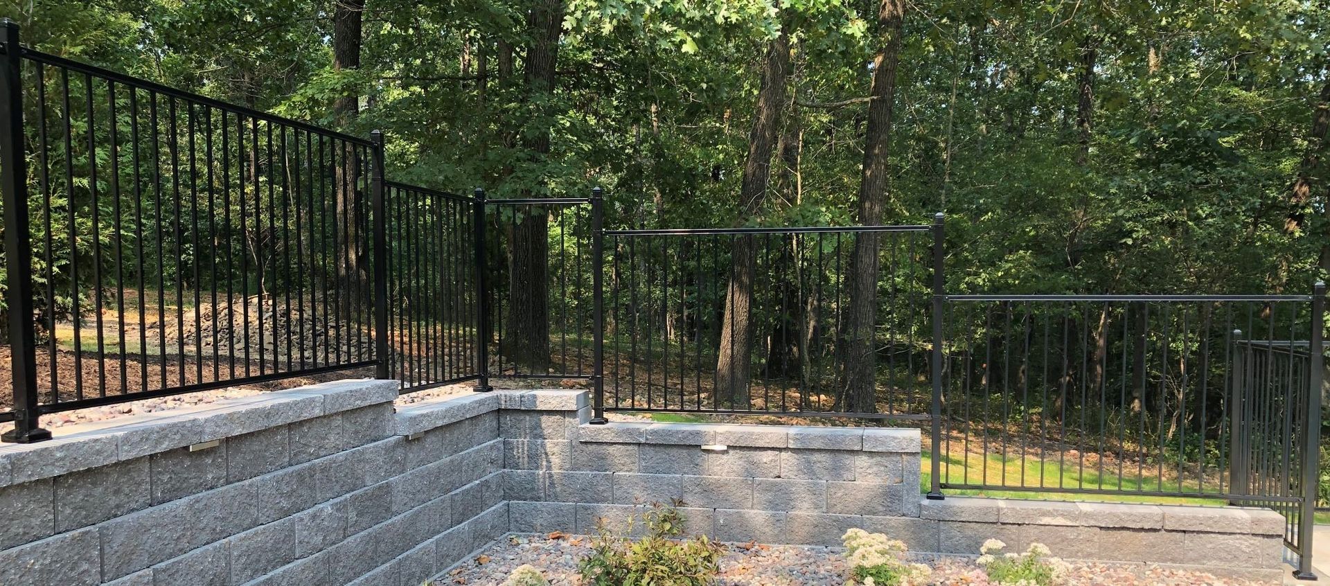 iron fence on top of stone wall