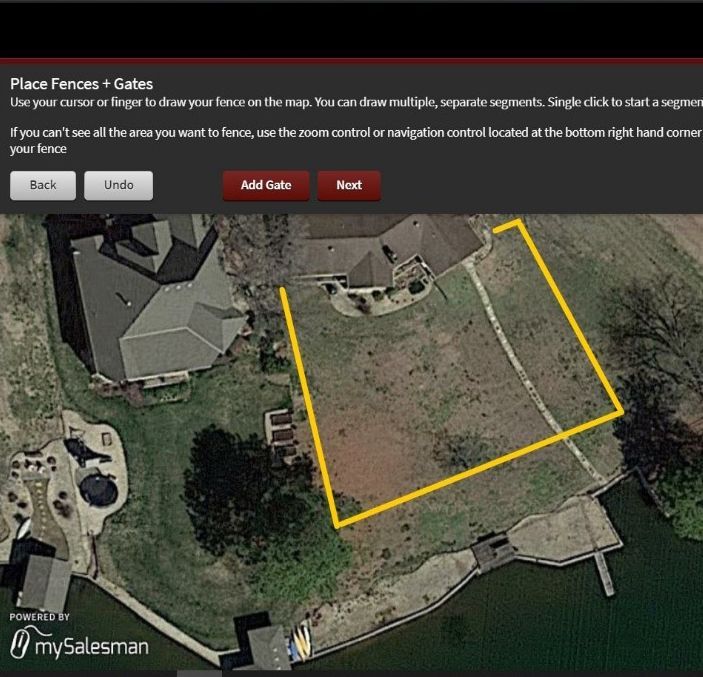 An aerial view of a fenced in area with a yellow line drawn around it