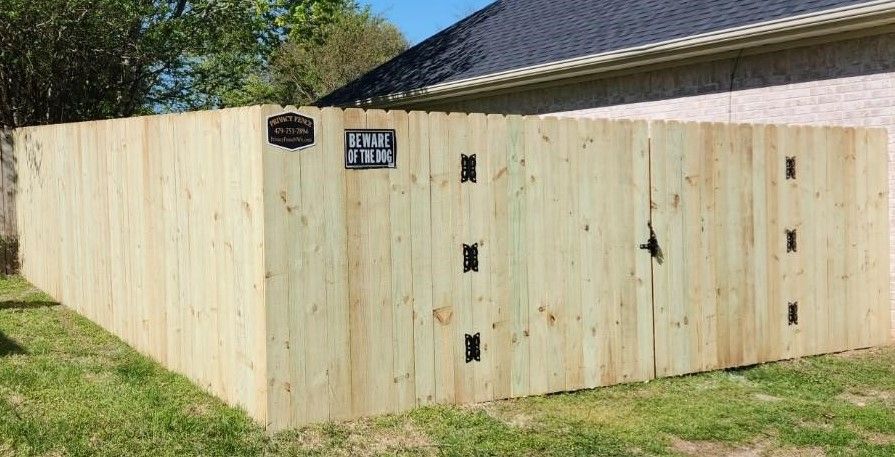 Pressure treated pine board to board fence with gate