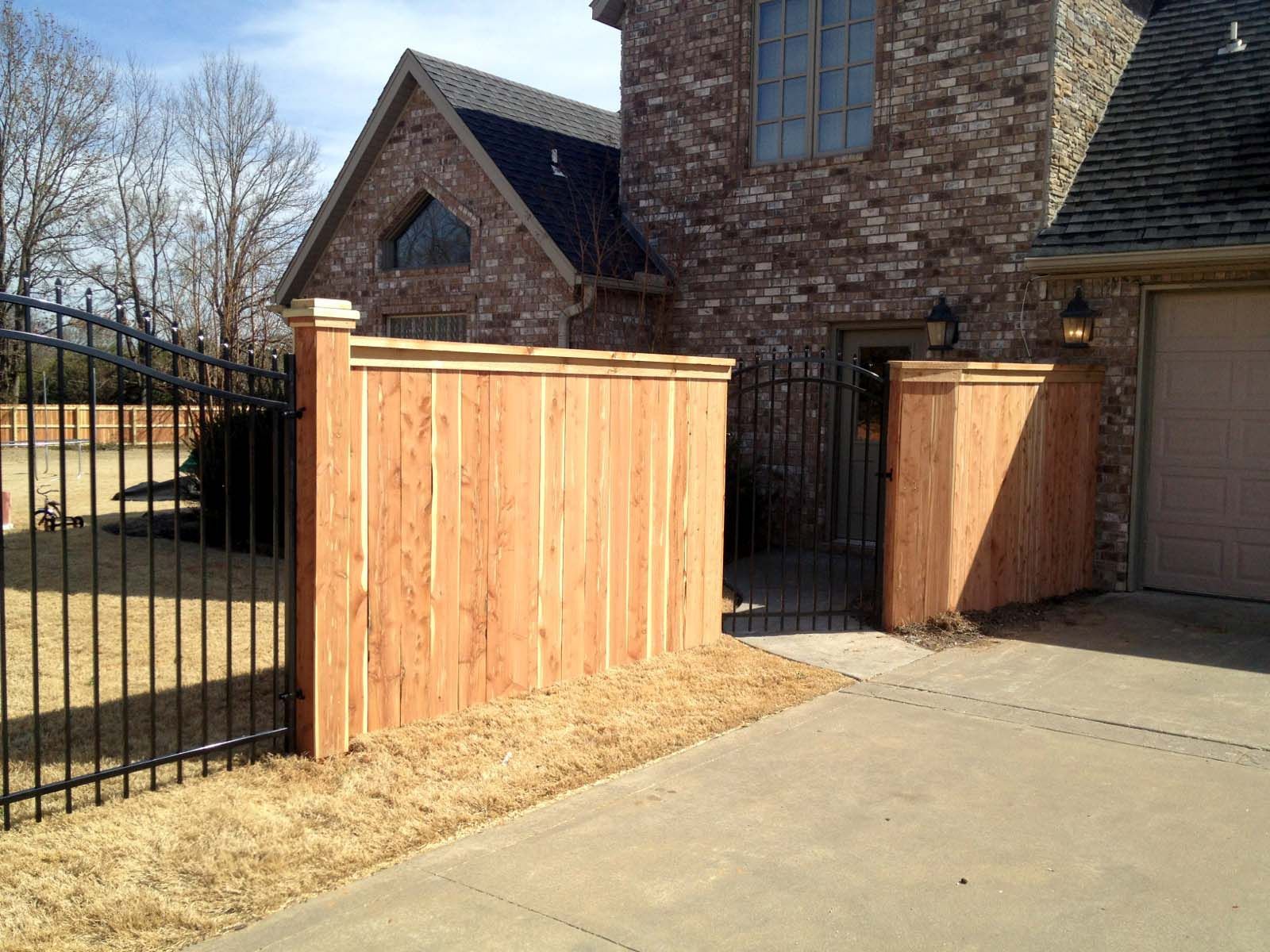 a brick house with a wooden fence in front of it