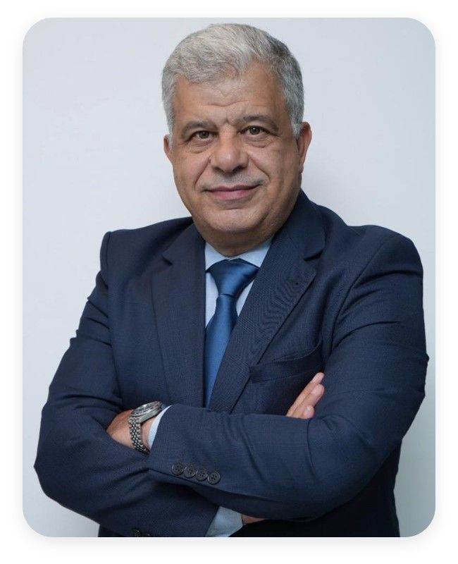 Man in blue suit, arms crossed, smiling. White background.