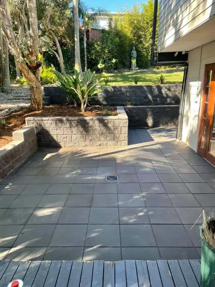 A Paved Outdoor Patio Featuring Stepped Stone Retaining Walls  — Creative Landscapes Coffs Harbour in Korora, NSW