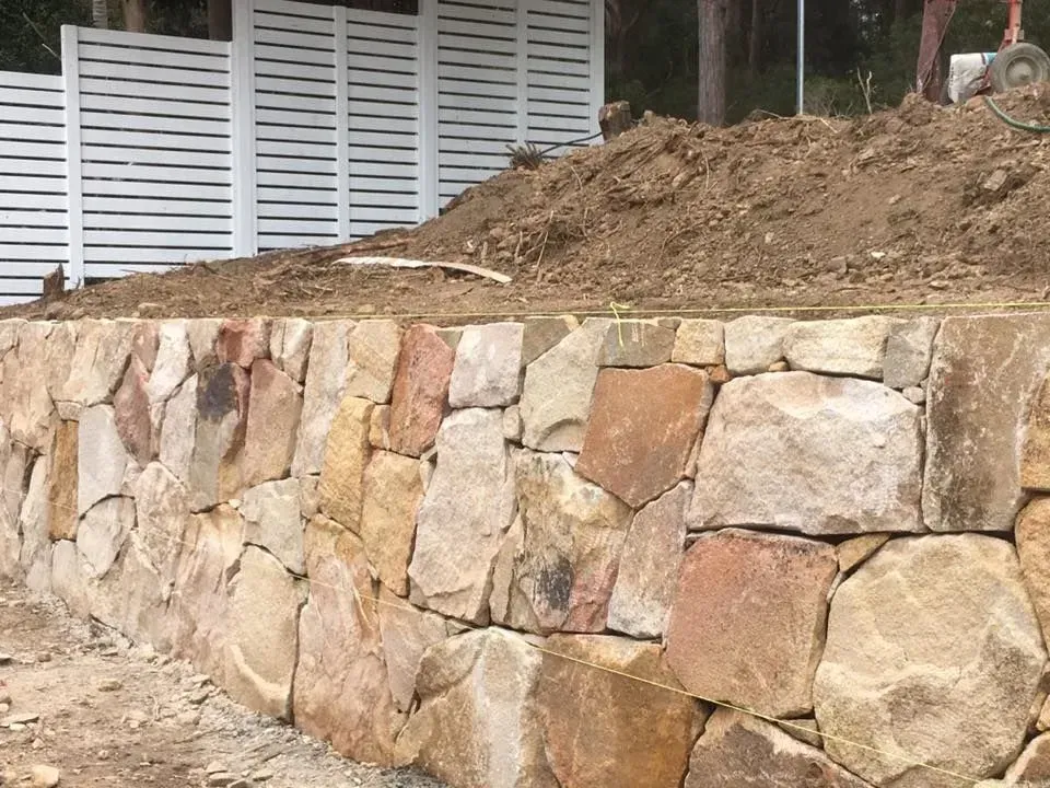 A Stone Retaining Wall Built with Natural — Creative Landscapes Coffs Harbour in Woolgoolga, NSW
