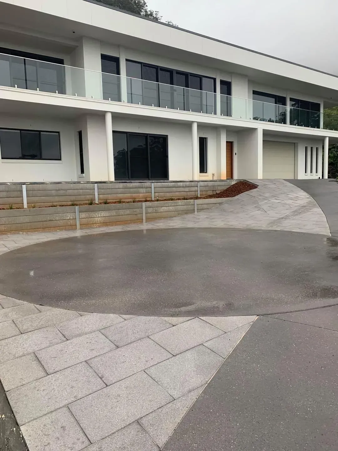 A Curved Driveway and Paved Patio Area — Creative Landscapes Coffs Harbour in Moonee Beach, NSW
