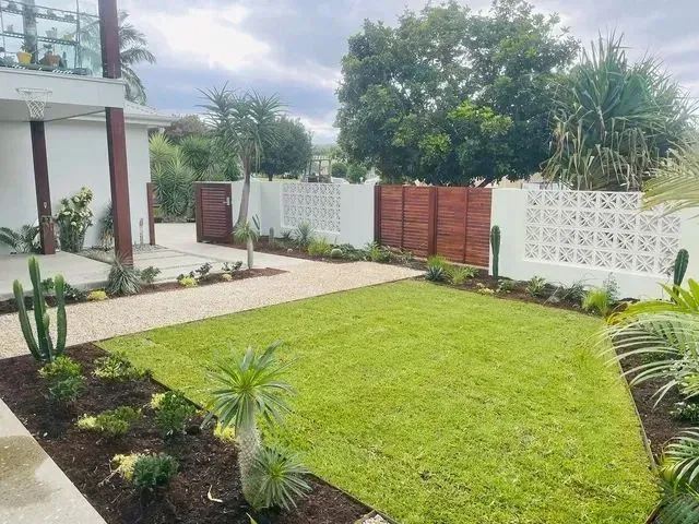 A Well-Maintained Lawn Bordered by Dark Mulch — Creative Landscapes Coffs Harbour in Woolgoolga, NSW
