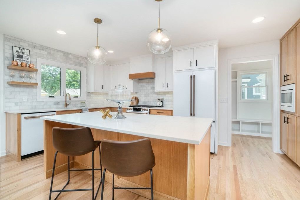 A Kitchen With A Large Island And Two Bar Stools – Olathe, KS - JJR Painting