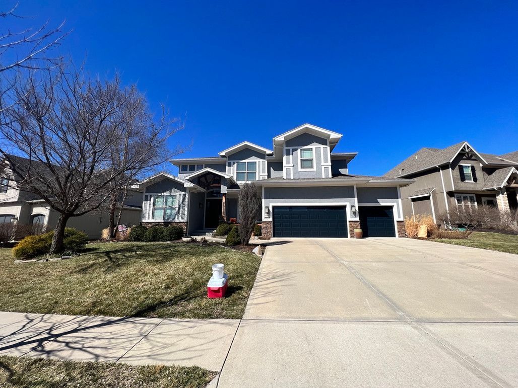 A Large House With A Large Driveway And A Blue Sky In The Background – Olathe, KS - JJR Painting