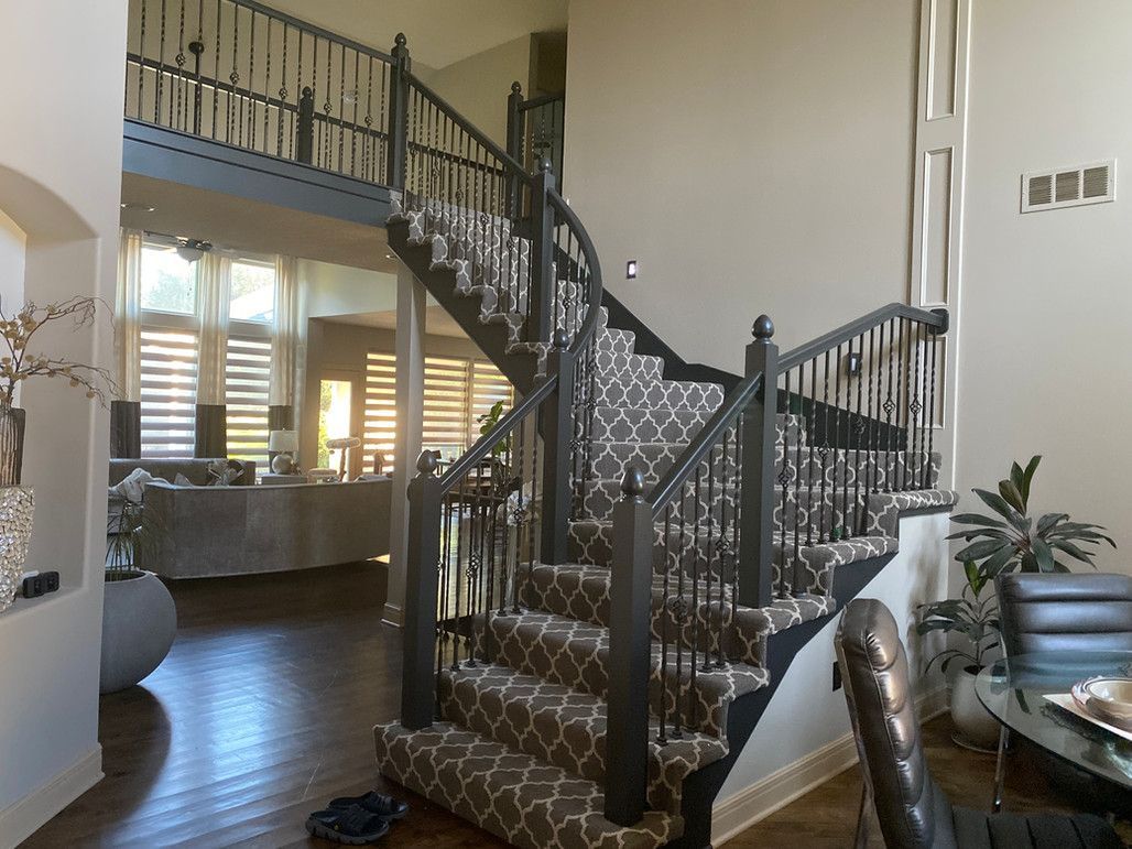 A Spiral Staircase In A Living Room With A Carpeted Staircase – Olathe, KS - JJR Painting