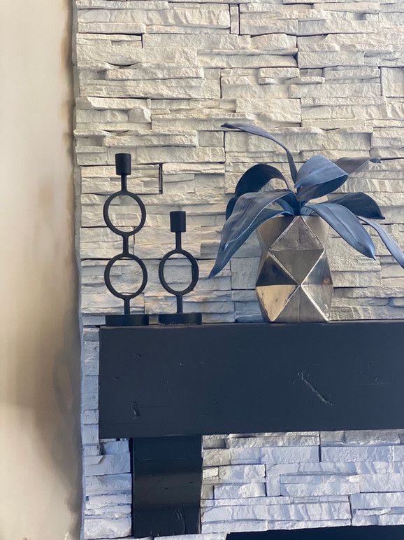 A Fireplace With A Plant And Candle Holders On It – Olathe, KS - JJR Painting