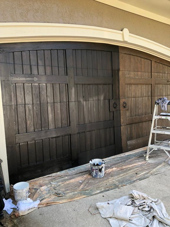 A Garage Door Is Being Painted With A Ladder In The Background – Olathe, KS - JJR Painting