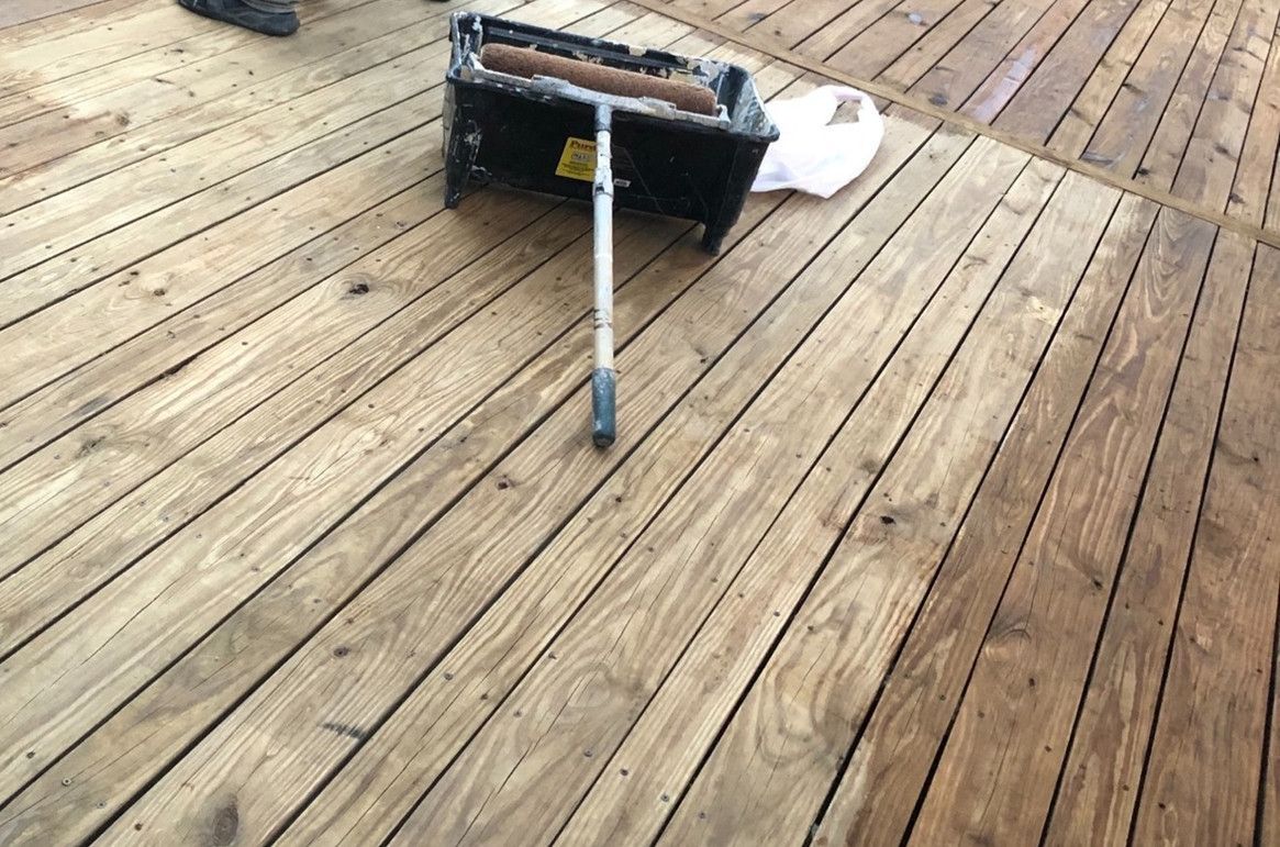 A Wooden Deck With A Mop And Bucket On It – Olathe, KS - JJR Painting