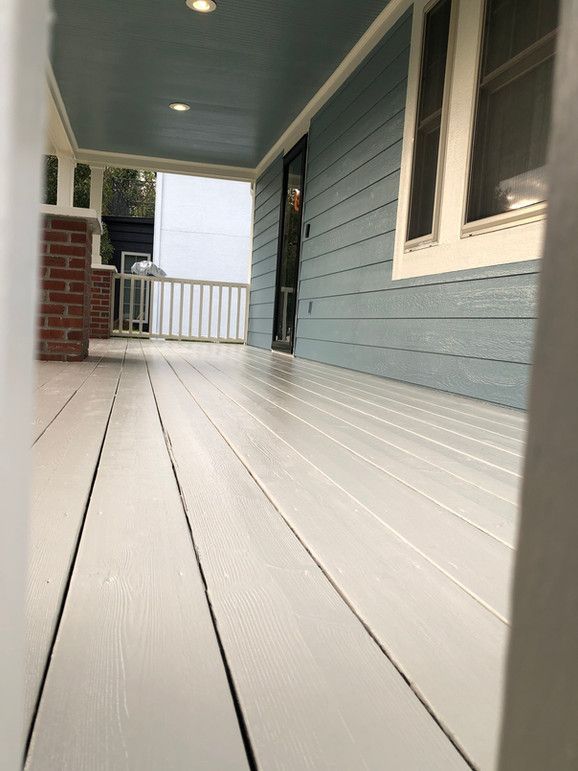 A Blue House With A White Porch And A White Railing – Olathe, KS - JJR Painting