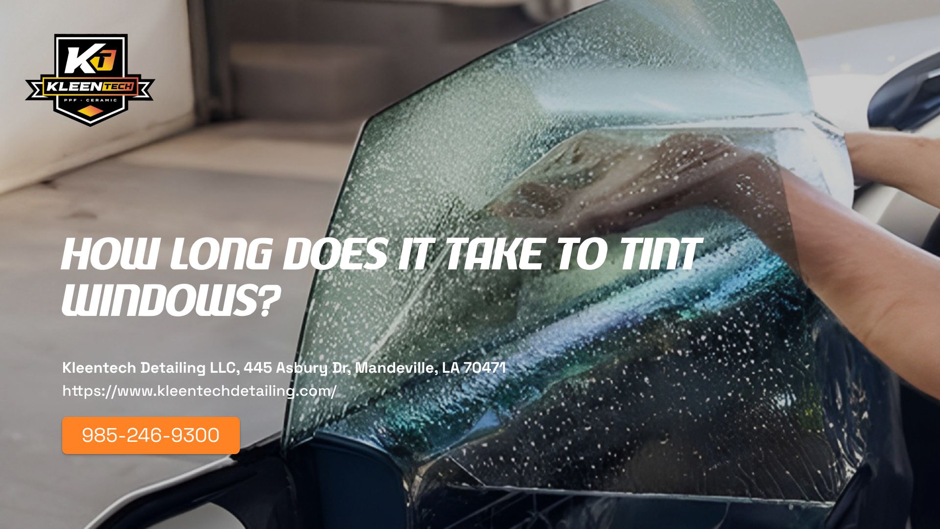 A person is applying tint to a car windshield.
