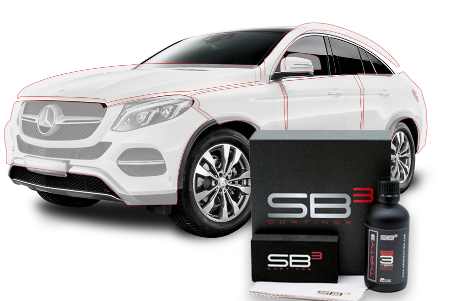 A white car is sitting next to a box and a bottle of sb3.