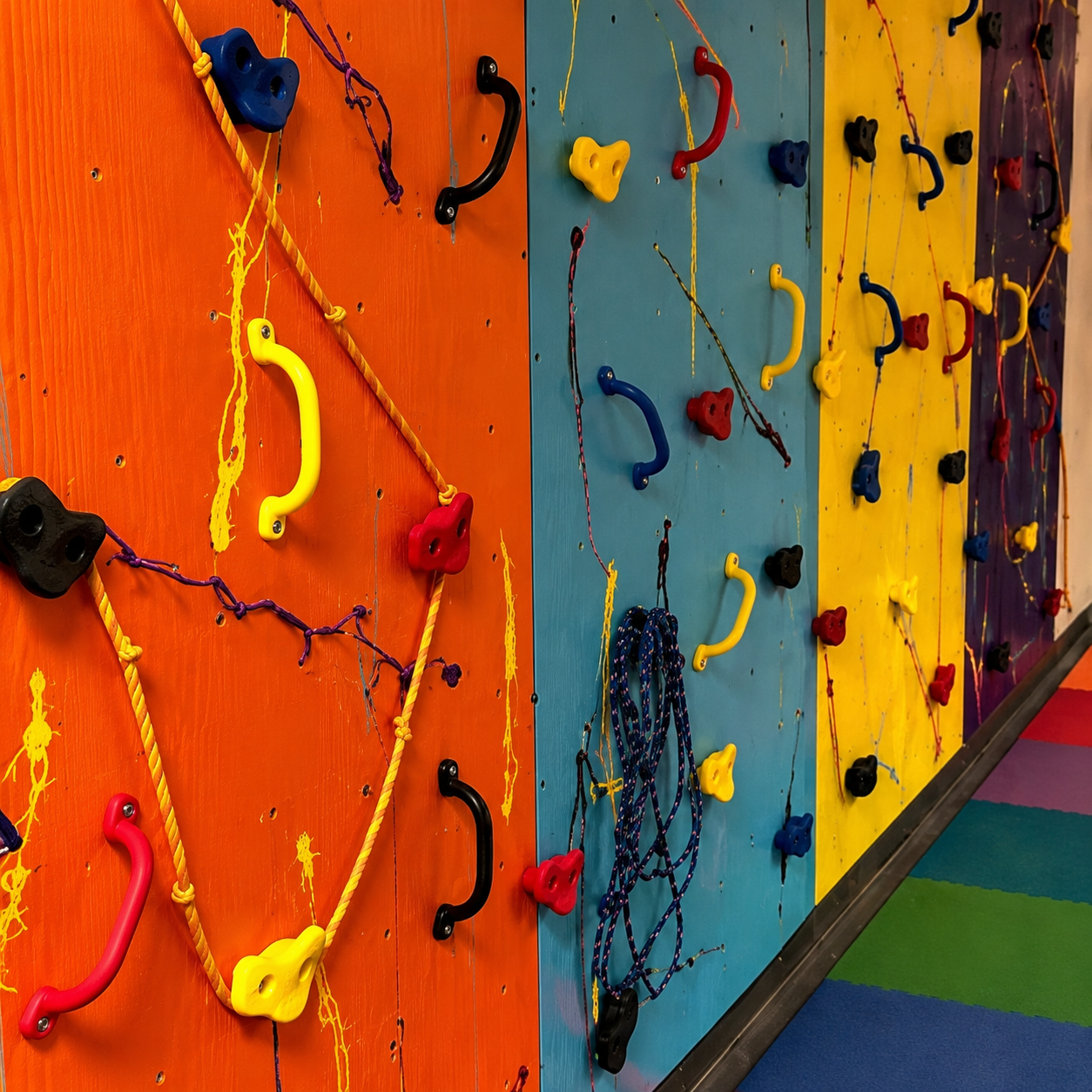 Colorful sensory climbing wall panels with handholds for therapy gyms, schools, and indoor play spaces