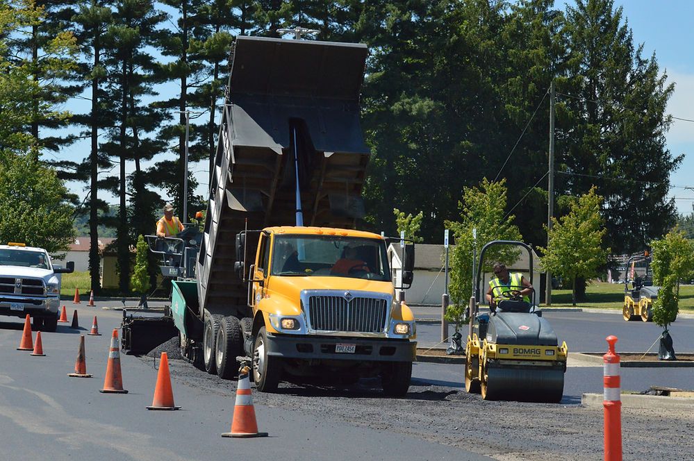 Truck Transferring the Asphalt in Paving Machine — Cambridge, OH — Parnell & Associates